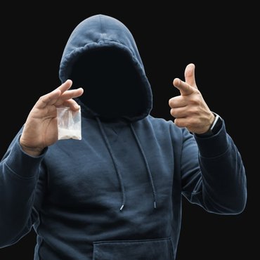 man-holding-plastic-bag-with-white-powder