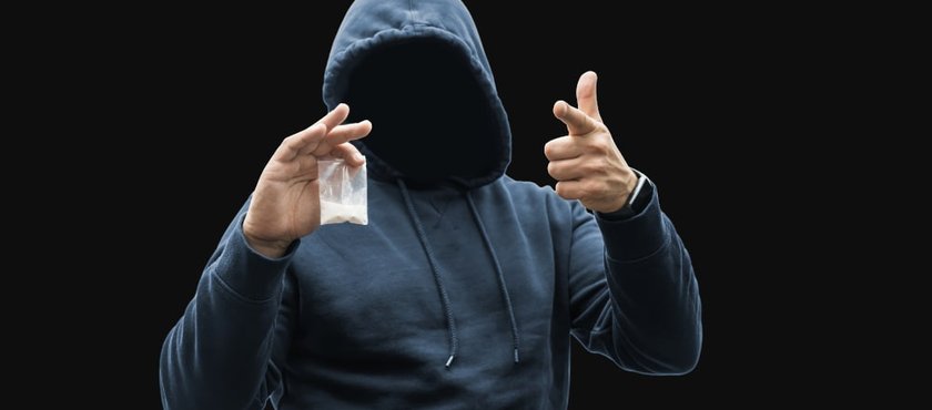 man-holding-plastic-bag-with-white-powder