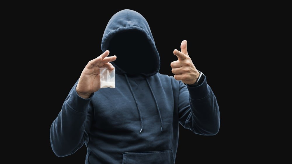 man-holding-plastic-bag-with-white-powder