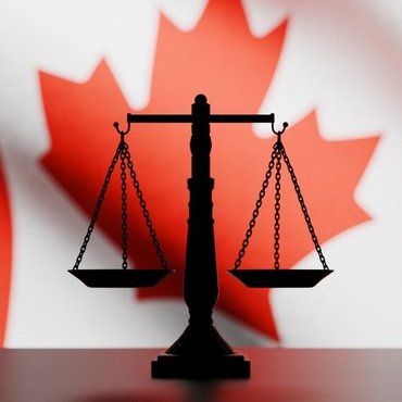 justice-scale-in-front-Canadian-flag