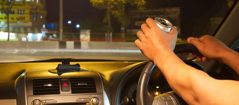 young-man-driving-with-open-beer-can
