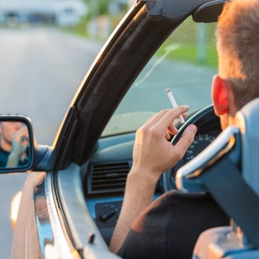 man-cigarette-car