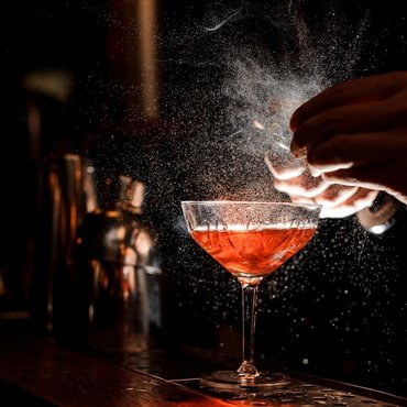 barmans-hands-sprinkling-cocktail