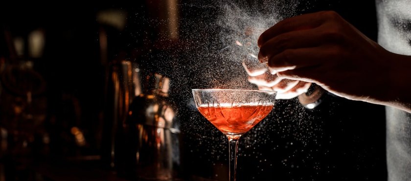 barmans-hands-sprinkling-cocktail