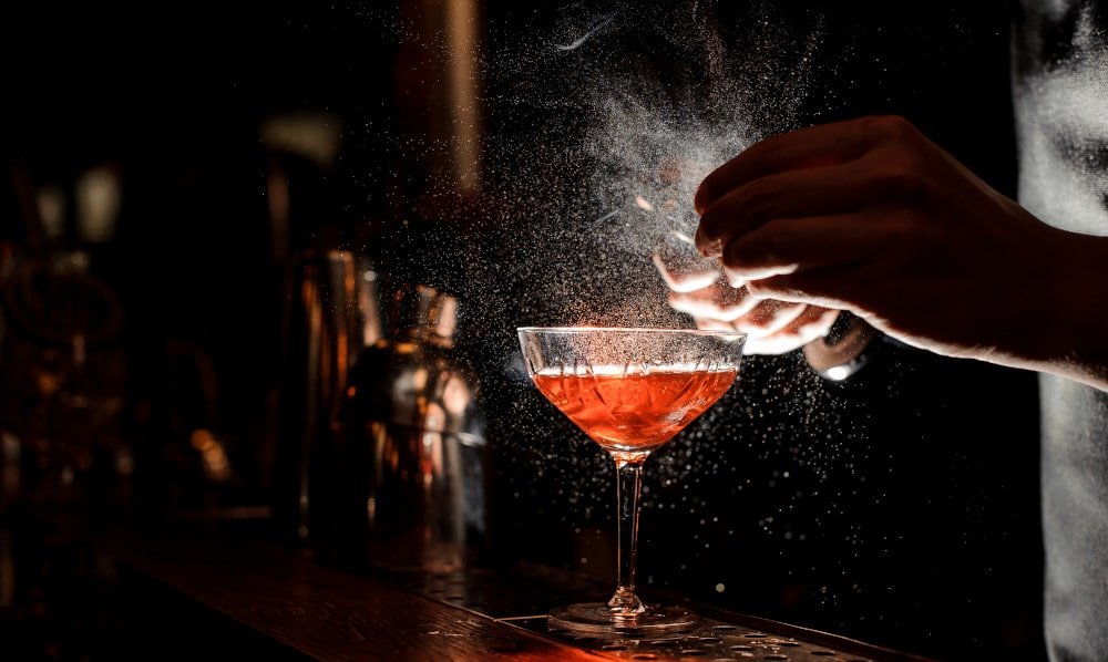 barmans-hands-sprinkling-cocktail