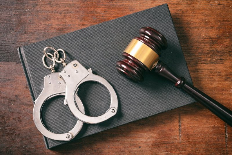 Handcuffs and gavel on a legal book representing criminal appeals process in Canada