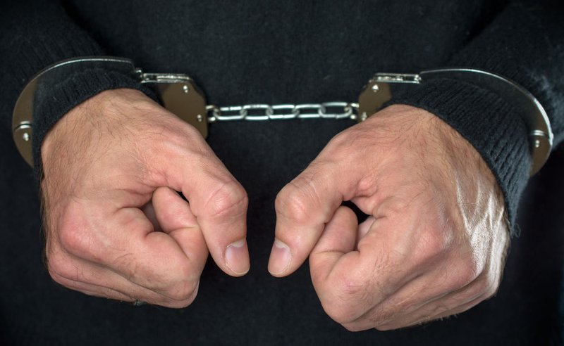 Handcuffed hands symbolizing serious criminal charges and long-term consequences arising from age-of-consent offences in Canada.