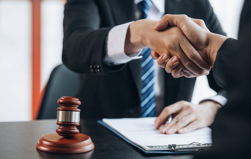 A criminal defence lawyer meeting with a client to discuss legal representation, billing options, and defence costs in Toronto.