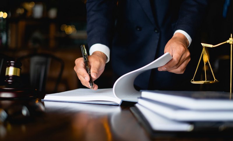 Close-up of a criminal defence lawyer reviewing legal documents, representing retainers, case preparation, and defence costs in Toronto.