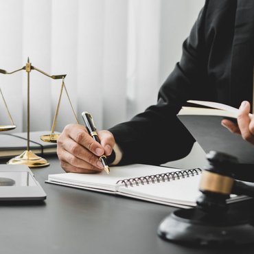 Legal counsel meeting with a client, illustrating how Canadian age-of-consent laws determine when dating a minor becomes a criminal offence.