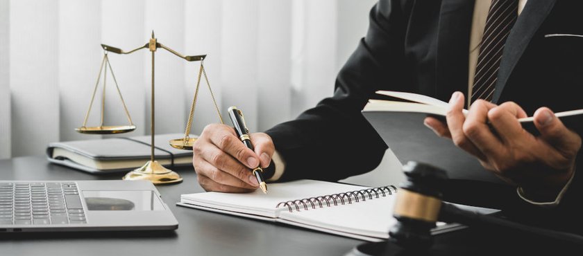 Legal counsel meeting with a client, illustrating how Canadian age-of-consent laws determine when dating a minor becomes a criminal offence.