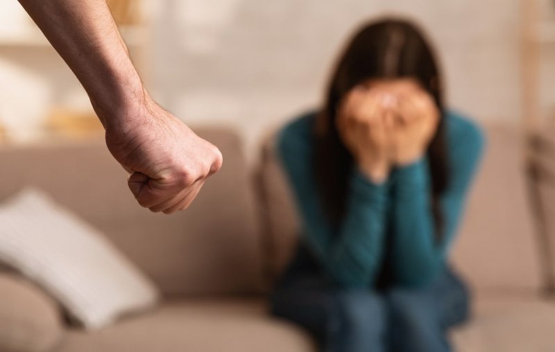 A man threatening a woman during a domestic assault incident illustrates zero-tolerance policies in Canada