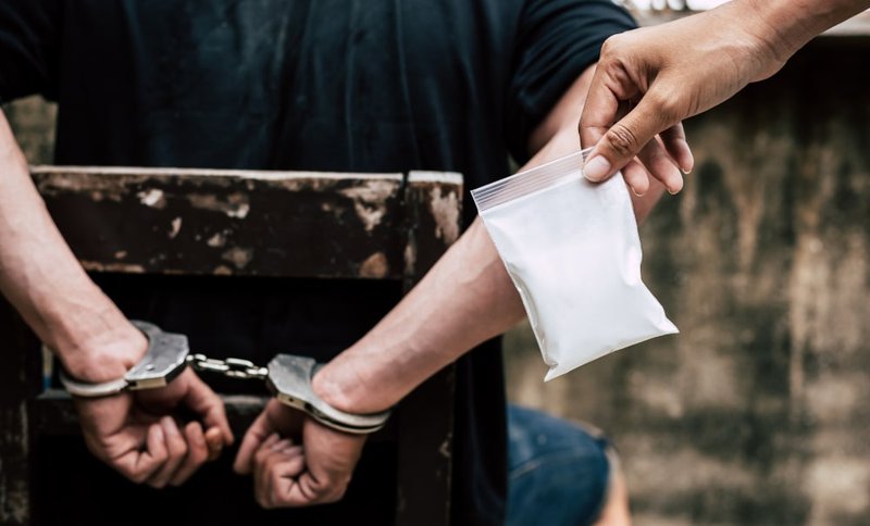 Person in handcuffs arrested for alleged drug trafficking in Canada