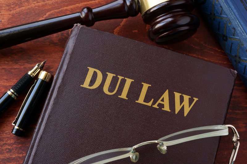 Law book and gavel symbolizing criminal convictions and how a DUI conviction may impact employment, licensing, and background checks in Ontario.