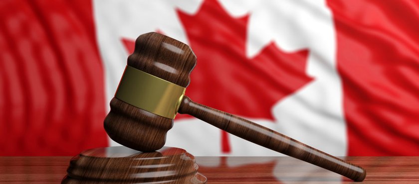 Judge’s gavel on a Canadian flag background representing the entrapment defence in Canadian criminal law