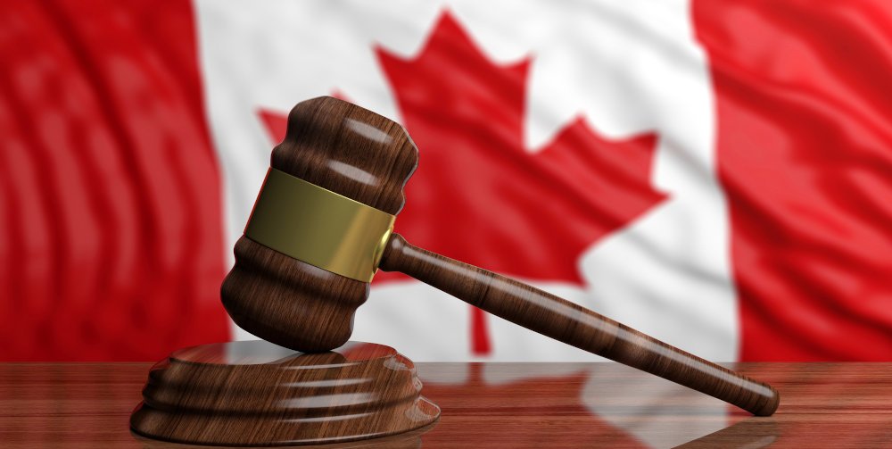Judge’s gavel on a Canadian flag background representing the entrapment defence in Canadian criminal law
