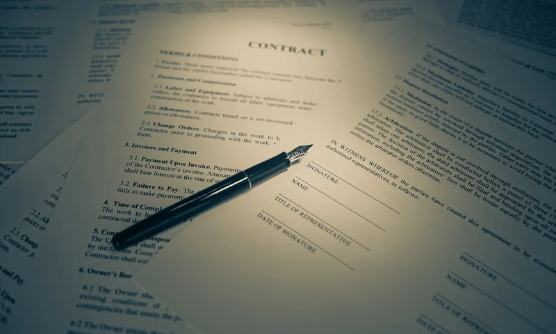 Pen on legal papers with signature lines