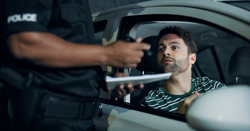 A police officer is conducting a roadside stop and checking a driver for possible DUI in Ontario.