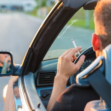 Editorial image introducing a legal guide on whether smoking cigarettes while driving is permitted under Ontario law.