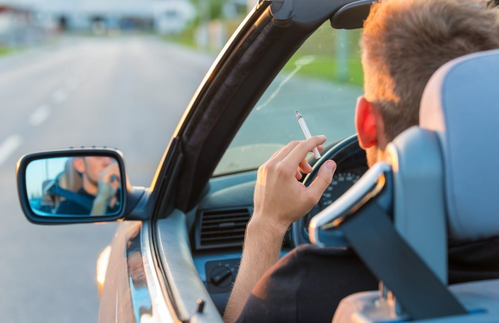 Editorial image introducing a legal guide on whether smoking cigarettes while driving is permitted under Ontario law.